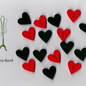 May include: Assortment of 15 heart-shaped buttons in red and black. The buttons have two holes each.