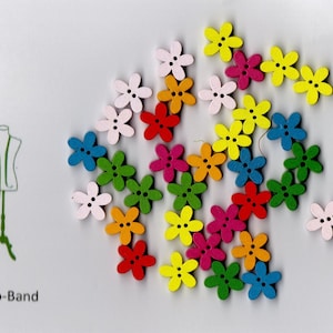 May include: Assortment of colorful wooden flower-shaped buttons. The buttons are in various colors, including pink, blue, green, yellow, orange, and red.