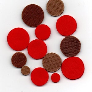 May include: Assortment of red and brown fabric circles of varying sizes.