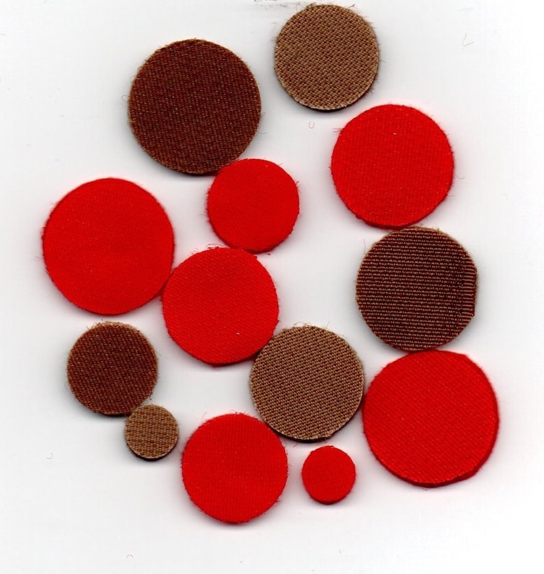 May include: Assortment of red and brown fabric circles of varying sizes.