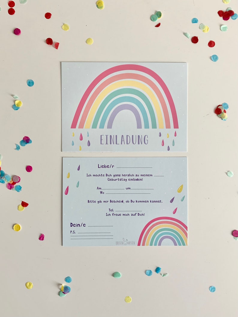 May include: A blue and white invitation card with a rainbow design and the text "EINLADUNG". The card has space for the recipient's name, date, time, and location of the event. The card also has a space for a personal message.
