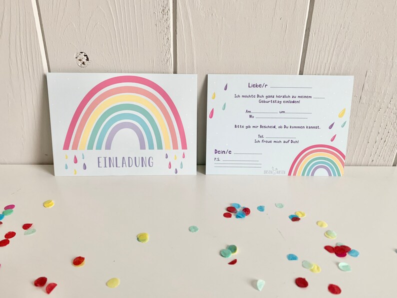 May include: A rainbow-themed birthday invitation with a colorful rainbow and raindrops. The text reads "Liebe/r" and "Ich m&ouml;chte Dich ganz herzlich zu meinem Geburtstag einladen!"
