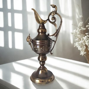 Bronze Empire Style Vase with Mythical Relief Heads and Sculpted Handle