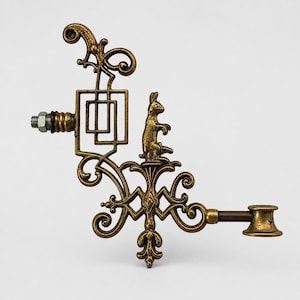 May include: Ornate brass bottle stopper featuring a standing rabbit figurine. The stopper has an intricate design with a square and scrollwork. The stopper has a screw and nut on one end and a small cup on the other.