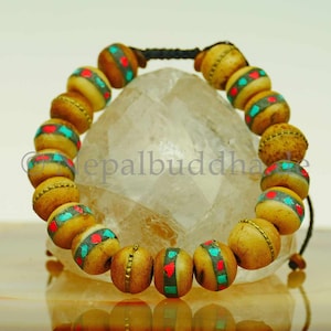 Pulseira de madeira Nepal com elementos redondos com incrustações de Buda s20