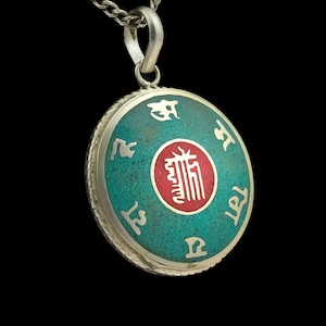 Decorated Buddhist amulet from Nepal, turquoise, silver, red, mandala, Kalachakra