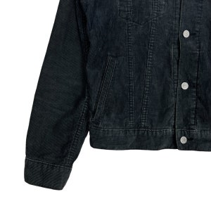 May include: A black corduroy jacket with a button closure and two front pockets. The jacket has a classic denim style.