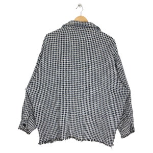 May include: A black and white checkered button-up shirt with a frayed hem.