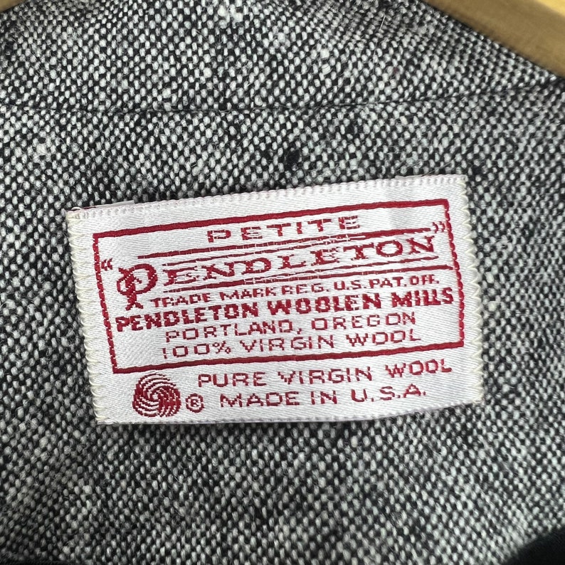 May include: White label with black text that reads "Petite Pendleton Trade Mark Reg. U.S. Pat. Off. Pendleton Woolen Mills Portland, Oregon 100% Virgin Wool Pure Virgin Wool Made in U.S.A."