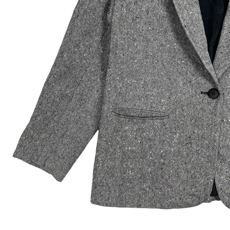 May include: A gray tweed blazer with a single button closure and a pocket on the left side.
