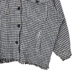 May include: A white, blue, and black patterned jacket with a frayed hem and long sleeves.