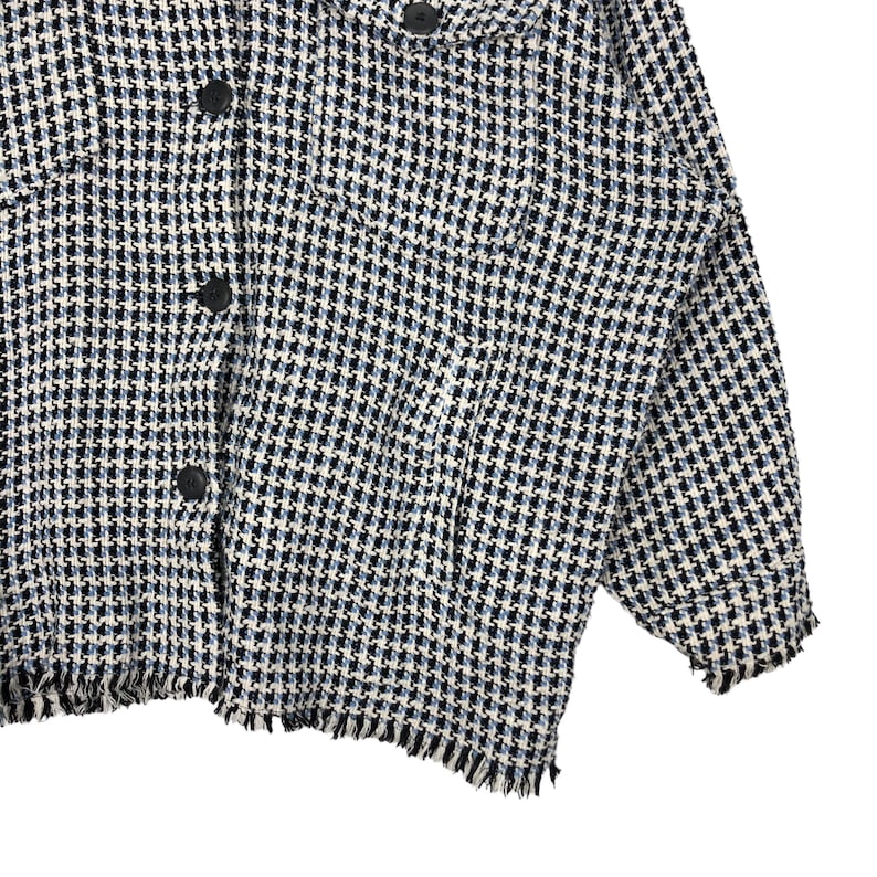 May include: A white, blue, and black patterned jacket with a frayed hem and long sleeves.