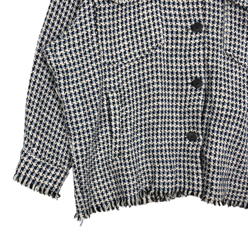 May include: A white and blue checkered jacket with a frayed hem and black buttons.