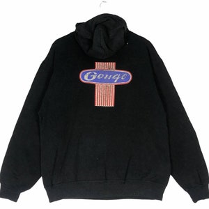 May include: Black hooded sweatshirt with a red, white, and blue logo that says "Gouge" in a blue oval.