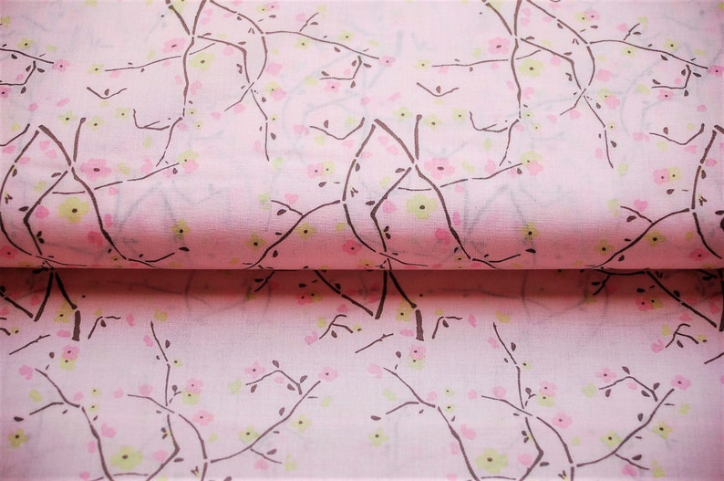 May include: Pink fabric with a repeating pattern of brown branches and pink and green flowers.