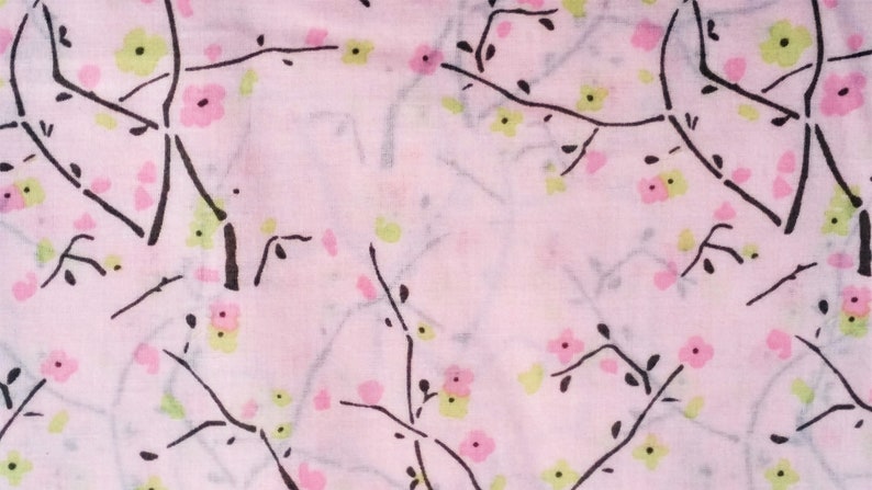May include: A pink fabric with a delicate floral pattern. The pattern features black branches with small pink and green flowers.