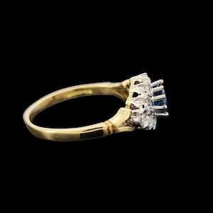 Vintage 18ct Yellow & White Gold Sapphire and Diamond Cluster Ring side view, on a black background
