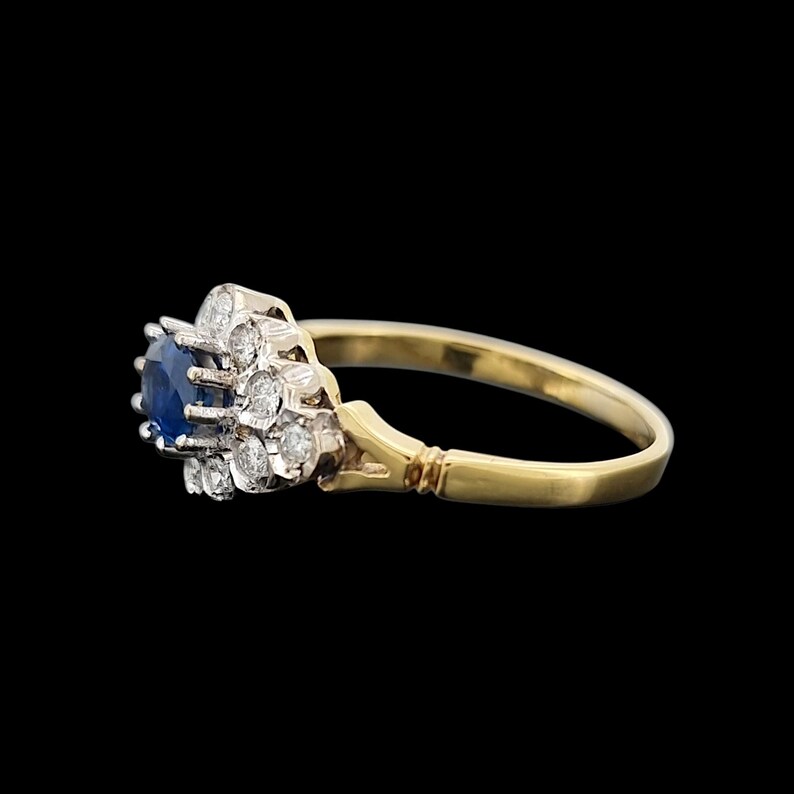 Vintage 18ct Yellow & White Gold Sapphire and Diamond Cluster Ring side view, on a black background