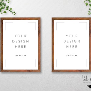 May include: Two brown wooden picture frames with white mounts and the text "YOUR DESIGN HERE" and "DIN A0 - A4" printed in black on a white background.