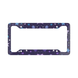 May include: A license plate frame featuring a dark blue backdrop adorned with a constellation of blue, purple, and white stars. The frame is rectangular with rounded edges and mounting holes.