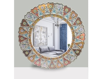 May include: A round mirror with a decorative frame made of colorful mosaic tiles. The frame features a geometric pattern with floral accents in shades of orange, yellow, blue, and green.
