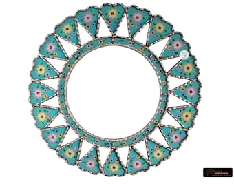 May include: A round, turquoise-colored mirror frame with a decorative design of white, yellow, and pink flowers. The frame is made of metal and has a scalloped edge.