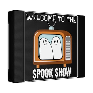 May include: A black canvas print with the text "Welcome to the Spook Show" in white. A cartoon television with two ghosts inside is featured in the centre of the print.