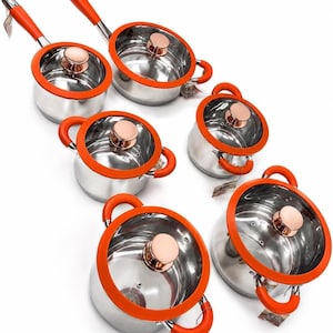 May include: A set of six stainless steel cooking pots and pans with bright orange silicone rims and handles. Each piece includes a glass lid featuring a metallic copper-colored knob. The cookware set varies in size, including saucepans and stockpots.