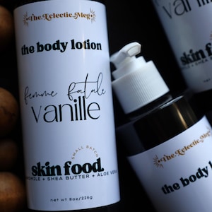 May include: White body lotion bottles with black text, including "the body lotion" and "femme fatale vanille." The bottles also feature "skin food" with shea butter and aloe vera. The net weight is 8oz/226g.