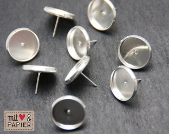 May include: Eight silver-toned earring settings with round bezels and posts. The bezels are smooth and shiny.