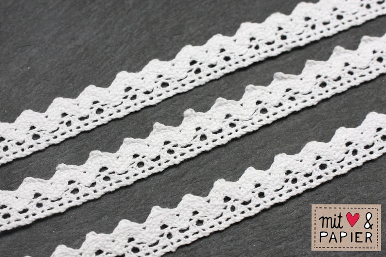 May include: White crochet trim with a scalloped edge. The trim is shown in three layers on a gray background.
