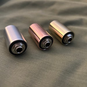May include: Three metal guitar cable adapters in silver, copper, and gold. Each adapter has a 1/4 inch jack.