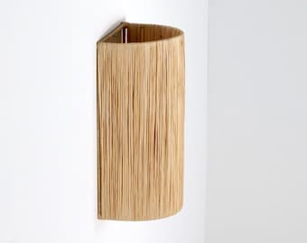 Wall light fixture with raffia