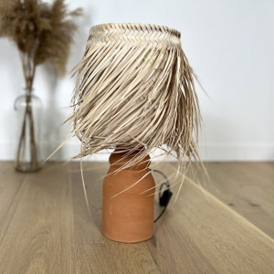 Fringed straw lampshade