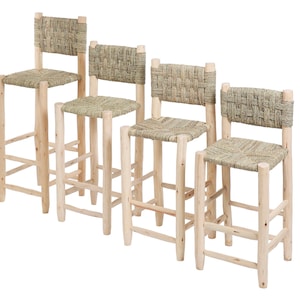 May include: Four natural wood bar stools with woven rush seats. The stools are arranged in a row from tallest to shortest.