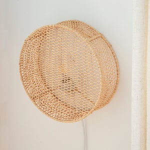 Round woven raffia wall light