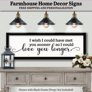 May include: A farmhouse-style sign with a black frame displays the text "I wish I could have met you sooner so I could love you longer." The sign is on a white background. The image also shows a decorative lantern and flowers.