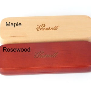 May include: Two rectangular wooden boxes, one maple and one rosewood, with the name "Garrett" engraved on each.