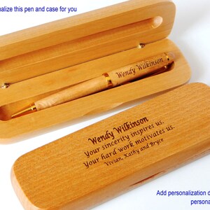 May include: A wooden pen and case set with personalized engraving. The pen is light brown with a gold trim and the case is made of natural wood. The engraving reads "Wendy Wilkinson Your sincerity inspires us. Your hard work motivates us. Vivian, Kathy and Bryce".