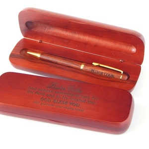 May include: A wooden pen and box set with an engraved message that reads "Pastor Colin God needed someone to care for His flock and so He created You, GOD BLESS YOU With gratitude, your church family".