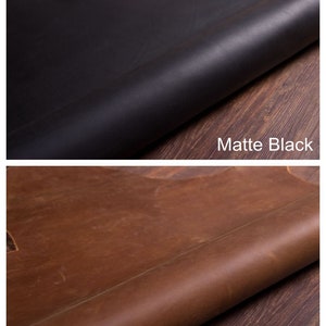 May include: Four leather swatches in different colors: dark brown, matte black, vintage brown, and tan brown. Each swatch is rolled up and placed on a wooden surface.