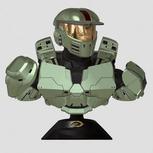 May include: A green and gold bust of a Master Chief from the Halo video game series. The bust is on a black base with the Halo logo.