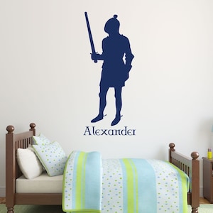 May include: A blue silhouette of a knight holding a sword with the name Alexander written below.