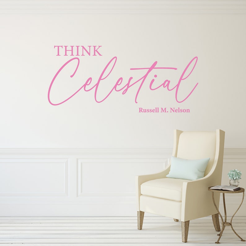 Soft pink vinyl decal with the text "Think Celestial Russel M. Nelson" quote. Set on the wall of a clean living room.