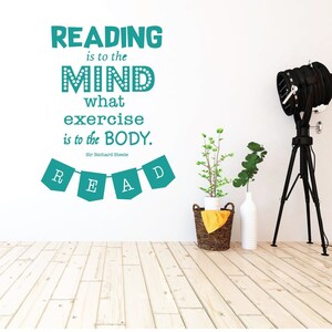 May include: Teal wall decal with the quote "Reading is to the mind what exercise is to the body. Sir Richard Steele" and a banner with the word "READ" in teal.