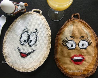 May include: Two crocheted pot holders shaped like eggs with faces. One is white with black eyes and a red mouth. The other is brown with black eyes and a red mouth.