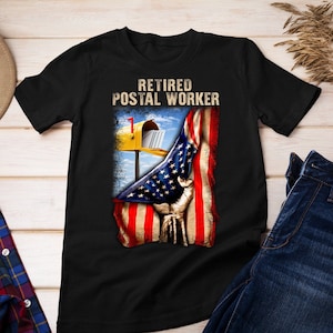 May include: Black t-shirt with the text "Retired Postal Worker" and an image of a mailbox with an American flag draped over it.