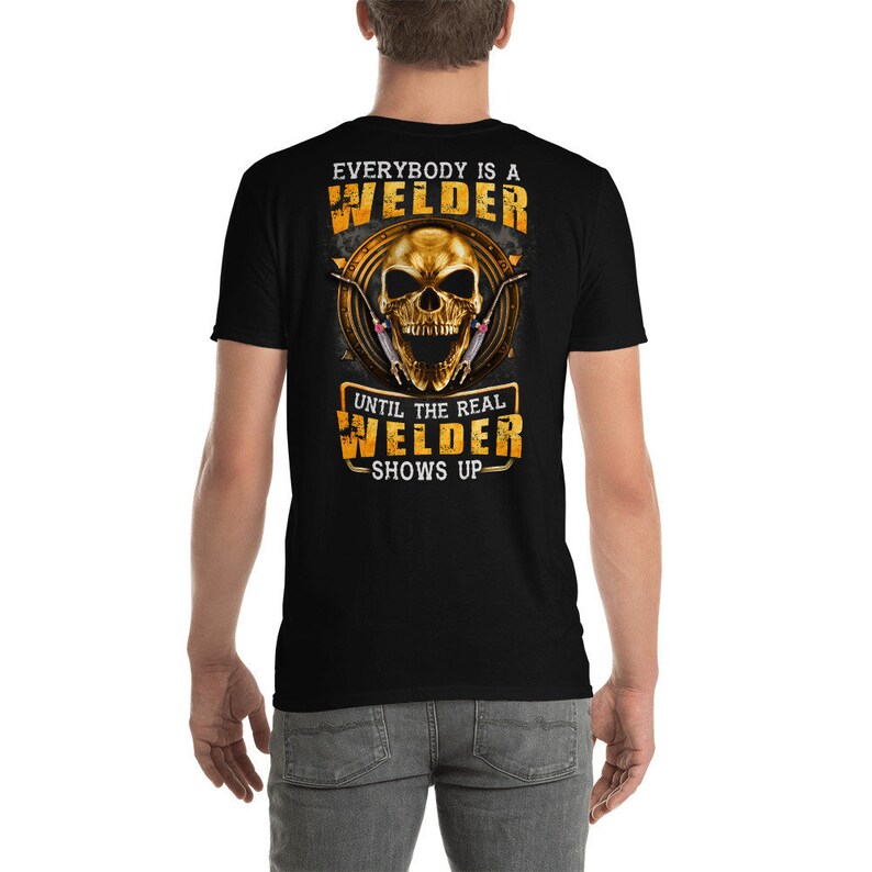 May include: Black t-shirt with a gold skull and welding tools graphic. The text "Everybody is a Welder Until the Real Welder Shows Up" is printed on the shirt.