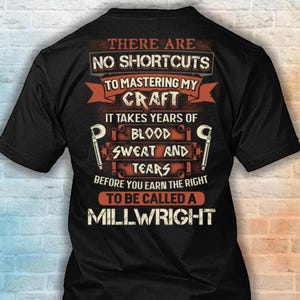 May include: A black short-sleeved t-shirt featuring orange and white text that reads: There are no shortcuts to mastering my craft it takes years of blood sweat and tears before you earn the right to be called a millwright, with two C-clamp icons.