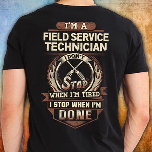 May include: Black t-shirt with the text "I'M A FIELD SERVICE TECHNICIAN" in white and brown. The design includes crossed screwdrivers and the phrase "I DON'T STOP WHEN I'M TIRED, I STOP WHEN I'M DONE."